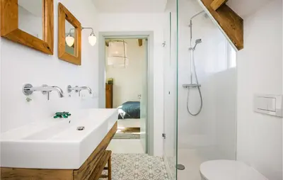 a bathroom with a sink and a shower at Zeevilla Duinhorst in Bergen aan Zee