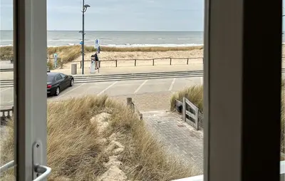 a view of the beach from a window at Zwaluwnest in Bergen aan Zee