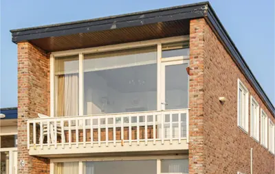 a balcony on the side of a brick building at Zwaluwnest in Bergen aan Zee