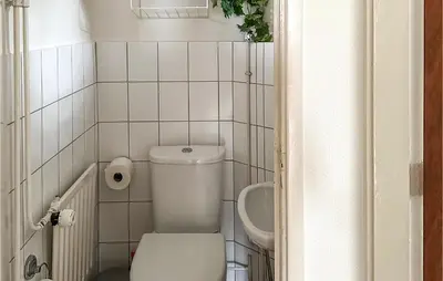 a small bathroom with a toilet and a sink at Duinennest in Bergen aan Zee