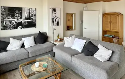 a living room with two couches and a coffee table at Duinennest in Bergen aan Zee
