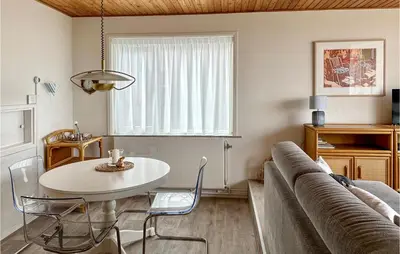 a living room with a table and a couch at Duinennest in Bergen aan Zee