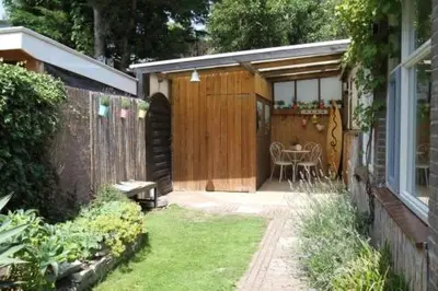 a backyard with a patio with a table in it at Studio Waves in Egmond aan Zee