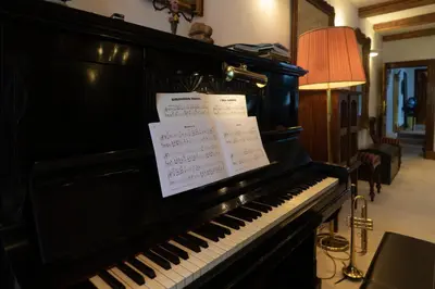 a black piano with notes on it in a room at B&B Singel Suites in Amsterdam