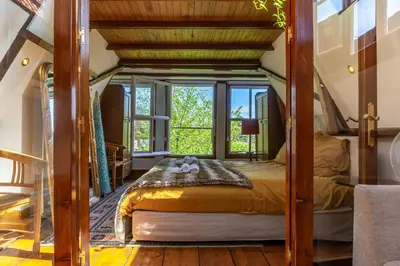 a bed in a room with a large window at B&B Singel Suites in Amsterdam