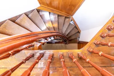 a spiral staircase in a building with a wooden floor at B&B Singel Suites in Amsterdam