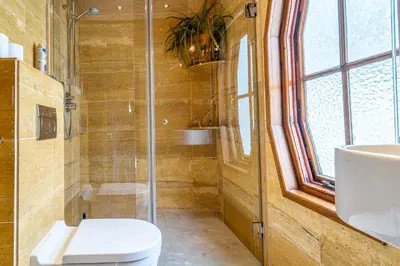 a bathroom with a shower and a toilet and a sink at B&B Singel Suites in Amsterdam
