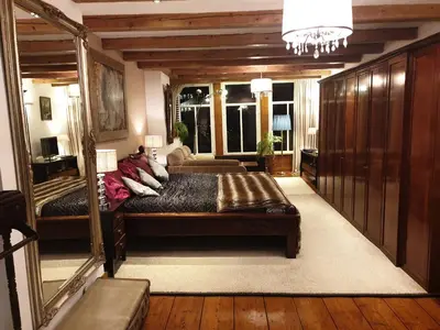 a bedroom with a large bed and a mirror at B&B Singel Suites in Amsterdam