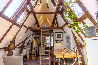 a room with a ceiling with wooden beams at B&B Singel Suites in Amsterdam