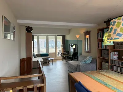 a living room with a couch and a table at Appartementen aan zee in Egmond aan Zee