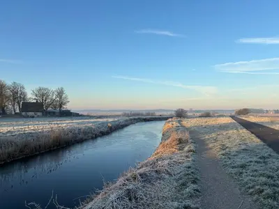 a river in a field with snow on it at klaproos Bergen NH in Bergen