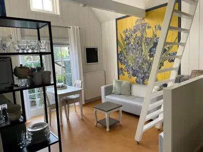 a living room with a loft bed and a couch at Bed en breakfast Onder aan de dijk in Warder