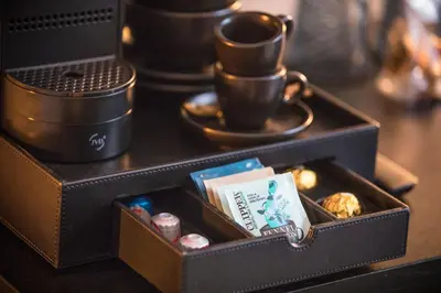 a black box with a cup on top of a table at Cavallaro Hotel in Haarlem