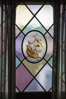 a stained glass window with a ship on it at Cavallaro Hotel in Haarlem