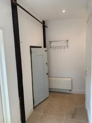 a room with a white wall and a white door at Smederij Schoorldam in Schoorl