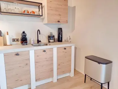 a kitchen with a sink and a trash can at Suite Pura Vida in Oud-Ade