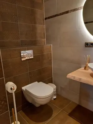 a bathroom with a toilet and a sink at Suite Pura Vida in Oud-Ade