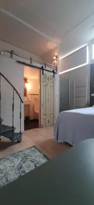 a bedroom with a bed and a room with a bathroom at Waterfront Studio in Amsterdam