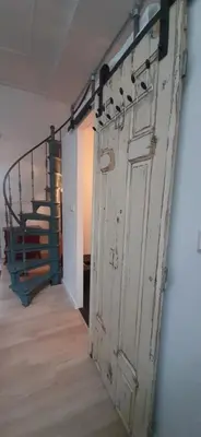 an old door in a room with a staircase at Waterfront Studio in Amsterdam