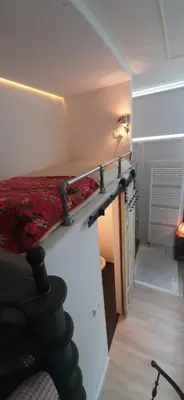 a small room with a bed on a wall at Waterfront Studio in Amsterdam