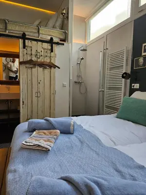 a bedroom with a bed with a towel on it at Waterfront Studio in Amsterdam