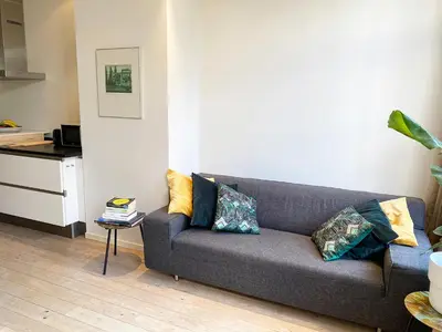 a living room with a couch and a table at The Canalview Retreat in Amsterdam