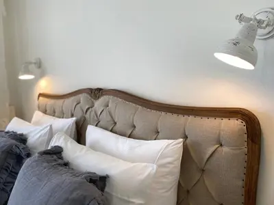 a bed with two pillows and two lights on the wall at Bed and Breakfast Amsterdam in Amsterdam