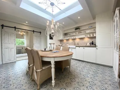 a kitchen with a dining room table and a chandelier at Bed and Breakfast Amsterdam in Amsterdam