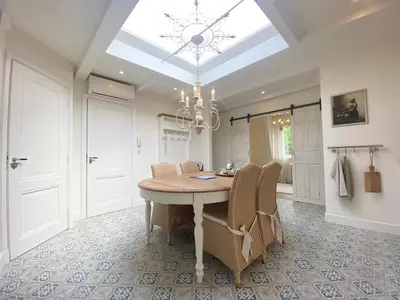 a dining room with a table and chairs and a skylight at Bed and Breakfast Amsterdam in Amsterdam