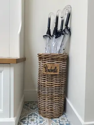 a basket filled with umbrellas sitting on a floor at Bed and Breakfast Amsterdam in Amsterdam