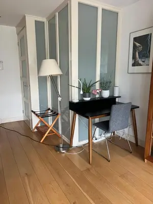 a room with a desk and a lamp and a chair at Great Apartment Amsterdam in Amsterdam