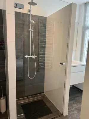a shower with a glass door in a bathroom at Great Apartment Amsterdam in Amsterdam