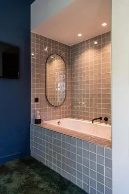 a bathroom with a tub and a mirror at Luxurious Residence in Vondelpark/Museum District in Amsterdam