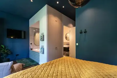 a bedroom with a large bed and a bathroom at Luxurious Residence in Vondelpark/Museum District in Amsterdam
