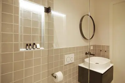 a bathroom with a sink and a mirror at Luxurious Residence in Vondelpark/Museum District in Amsterdam