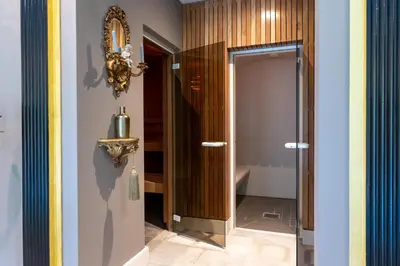 a bathroom with a glass door in a room at Amsterdamgarden - stunning garden villa with pool close to Amsterdam in Laren