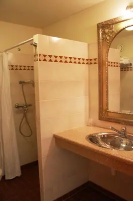 a bathroom with a sink and a mirror and a shower at Jachthaven Hotel Borger in Vinkeveen