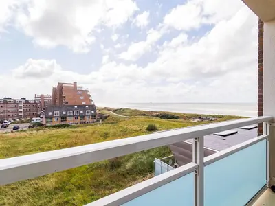 a view of the beach from the balcony of a condo at Apartment near North Sea and Lighthouse in Egmond aan Zee