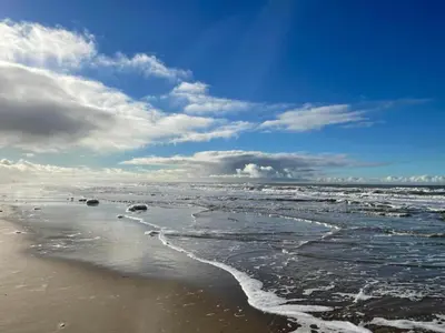 a view of the ocean on a beach at Apartment near North Sea and Lighthouse in Egmond aan Zee