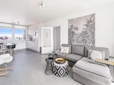 a living room with a couch and a table at Apartment near North Sea and Lighthouse in Egmond aan Zee