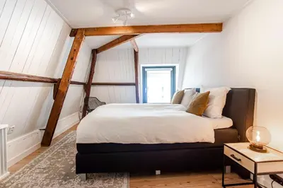 a bedroom with a large bed in a room at Casa by Sellas in Zandvoort