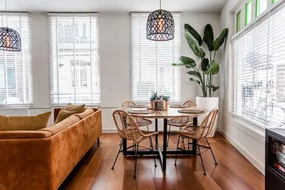 a living room with a couch and a table and chairs at Casa by Sellas in Zandvoort