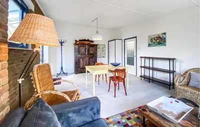 a living room with a table and chairs at Bergenhuisje in Bergen aan Zee