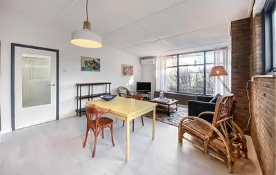 a living room with a table and chairs at Bergenhuisje in Bergen aan Zee
