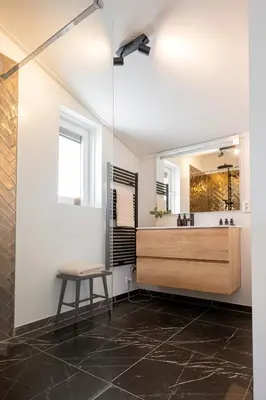 a bathroom with a glass shower and a sink at Dromen in de duinen by Droomvilla in Sint Maarten