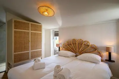a bedroom with a large white bed with towels on it at Relaxen aan de kust by Droomvilla in Sint Maarten