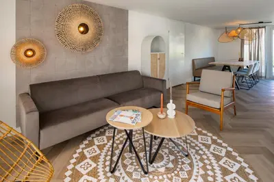 a living room with a couch and a table at Buiten aan zee by Droomvilla in Sint Maarten