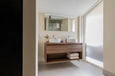 a bathroom with two sinks and a mirror at Modern Sint Maarten by Droomvilla in Sint Maarten