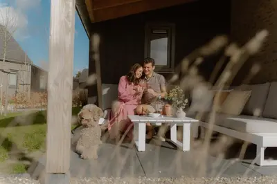 a man and woman sitting on a porch with a teddy bear at Modern Sint Maarten by Droomvilla in Sint Maarten