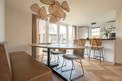 a dining room with a table and chairs at Slapen aan zee by Droomvilla in Sint Maarten